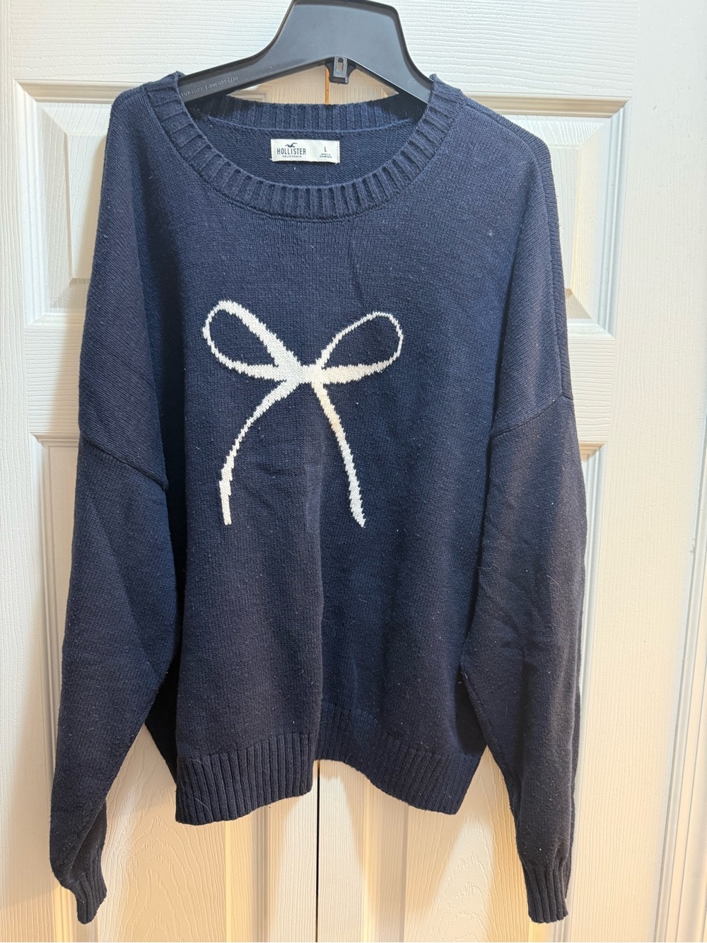 Large Hollister Navy Sweater with White Bow Graphic